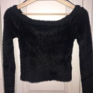 woman’s black fuzzy top